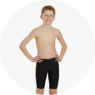 Young boy wearing black swim jammers with red side stripes, standing with hands on hips. Ideal for competitive swimming and training sessions.