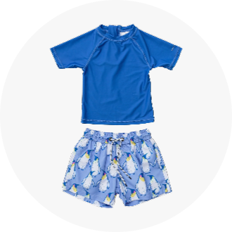 Blue short-sleeve swim shirt paired with blue swim trunks featuring a playful penguin pattern. Ideal for youth swimwear, providing comfort and style for swimming activities.