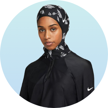 Woman wearing black swim hijab with white pattern, featuring a high neck and zip closure, suitable for modest swimwear. Ideal for comfortable and stylish swimming in U.S. Masters Swimming events.