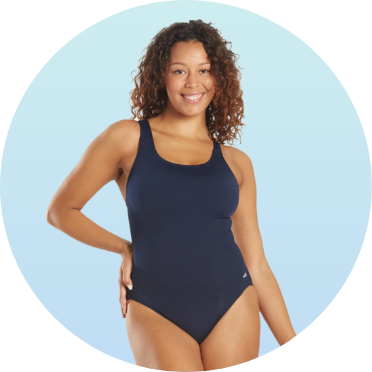 Woman wearing a navy blue one-piece swimsuit, smiling against a light blue background. The swimsuit features a scoop neckline and comfortable fit, ideal for swimming and water activities.