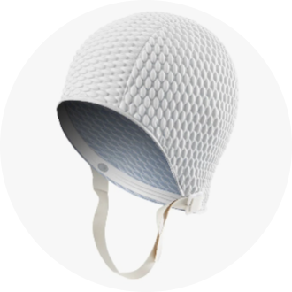 White textured swim cap with a chin strap, designed for competitive and recreational swimmers. The cap features a honeycomb pattern for enhanced grip and comfort. Ideal for protecting hair and reducing drag in the water.