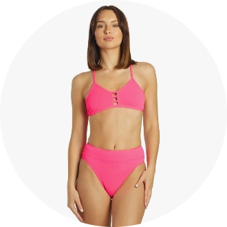 Woman wearing a bright pink two-piece swimsuit with a high-waisted bottom and a strappy top. The swimsuit is designed for optimal comfort and style, ideal for swimming and beach activities.