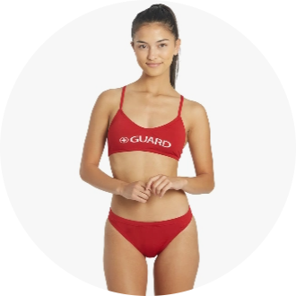 Female model wearing a red two-piece swimsuit with "GUARD" printed on the top. Ideal for lifeguards, the swimwear features a sporty design suitable for active use.